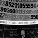 Un señor delante de un cartel del número Pi en la década de los 60.